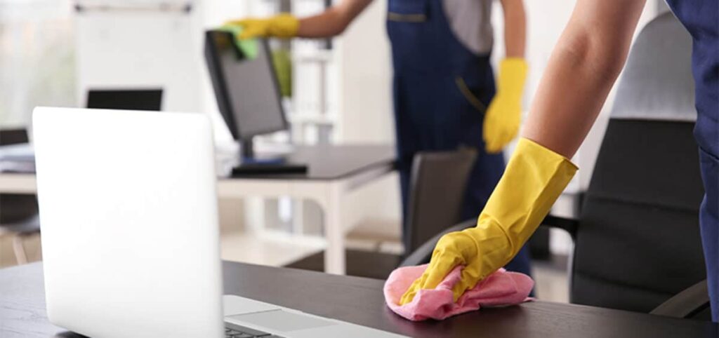 Professional Cleaner wiping the Office Table